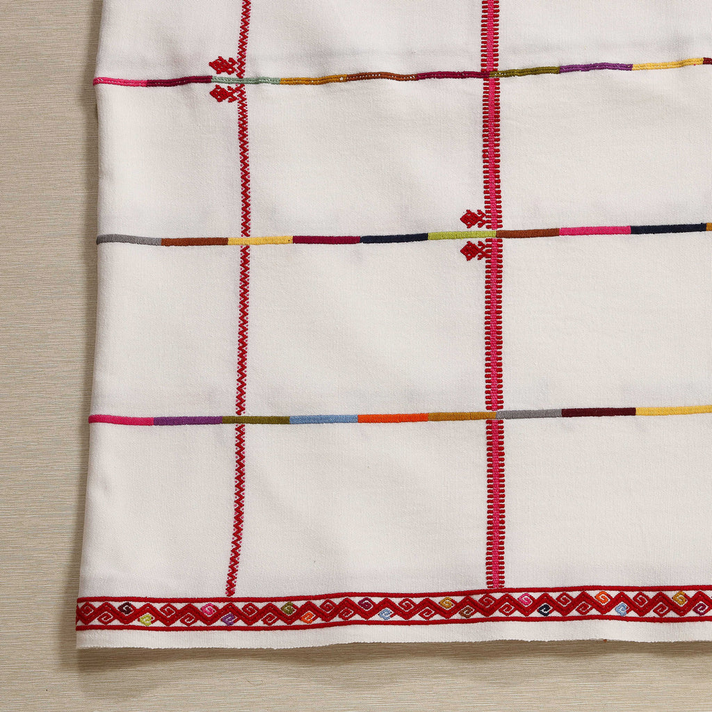 Handwoven tablecloth with embroidered red borders and frog motif