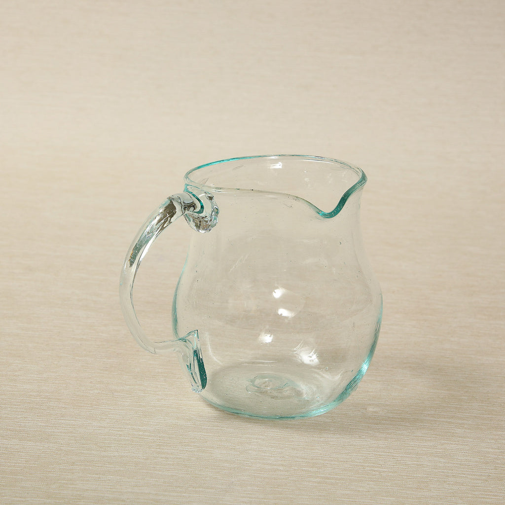 A Small Clear Hand Blown Glass Amber Glass Pitcher With a Pinched Spout and  a Clear Stretched Applied Glass Handle. Misc 862 