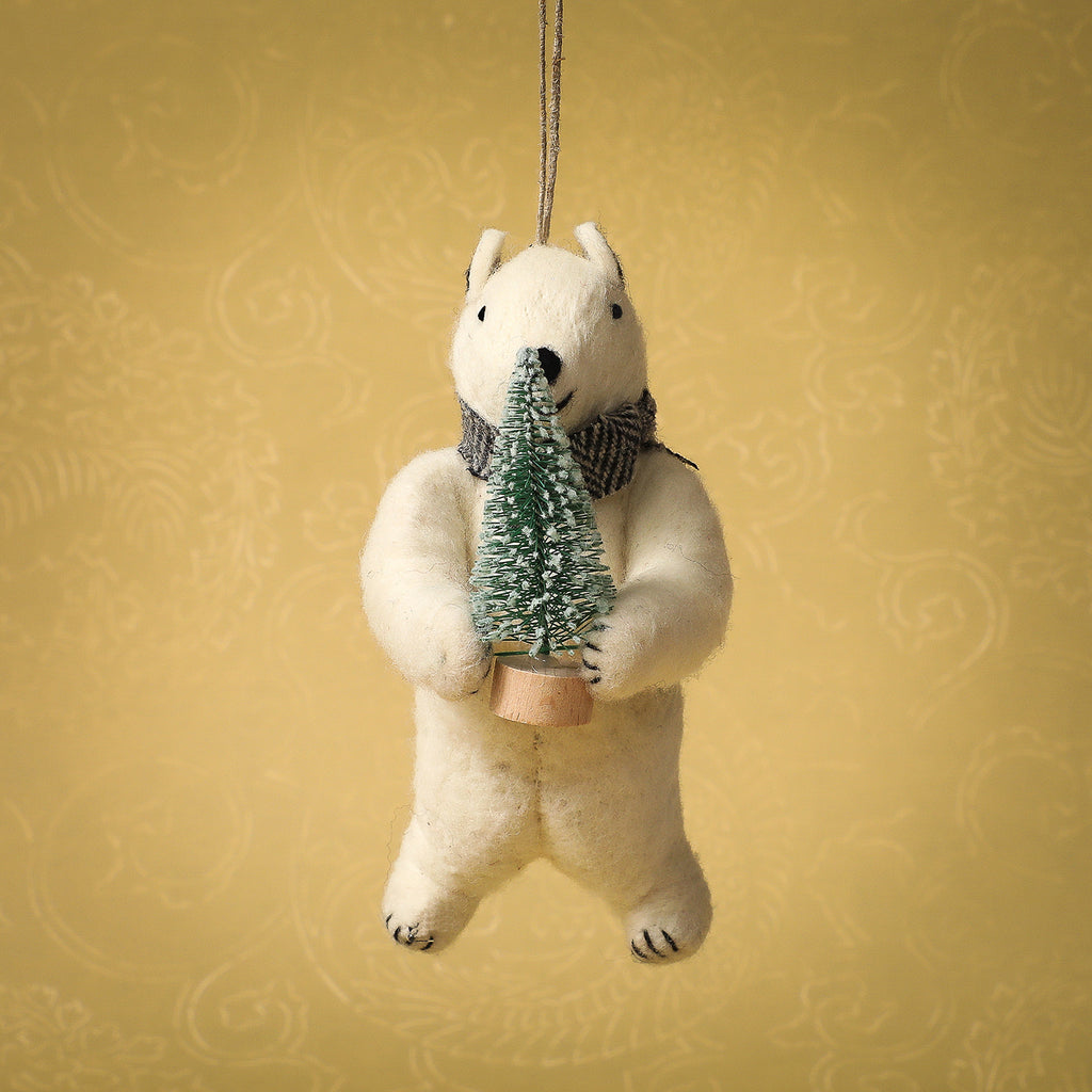 Felt polar bear holding a tree ornament