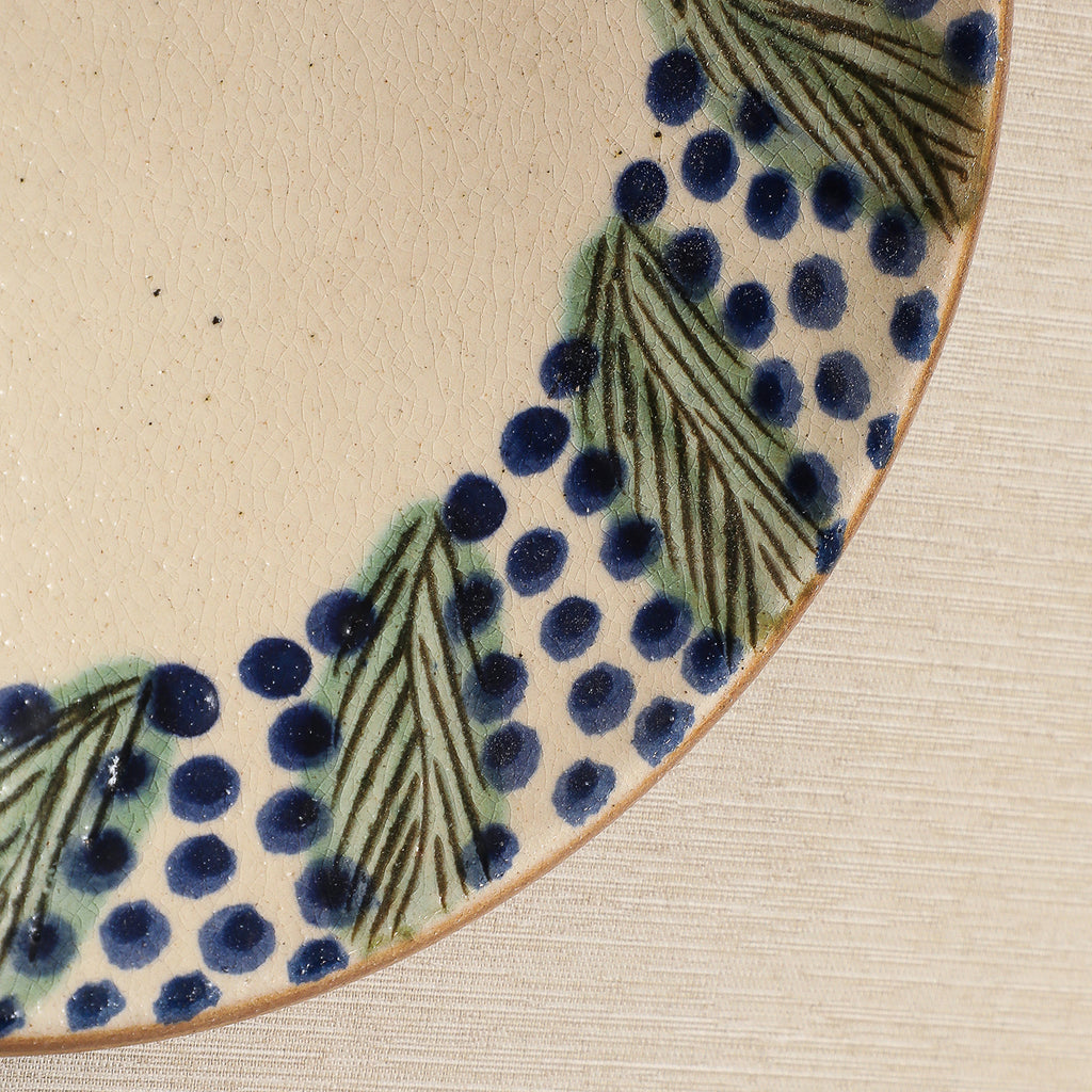 Hand painted plate with wreath decorated edge