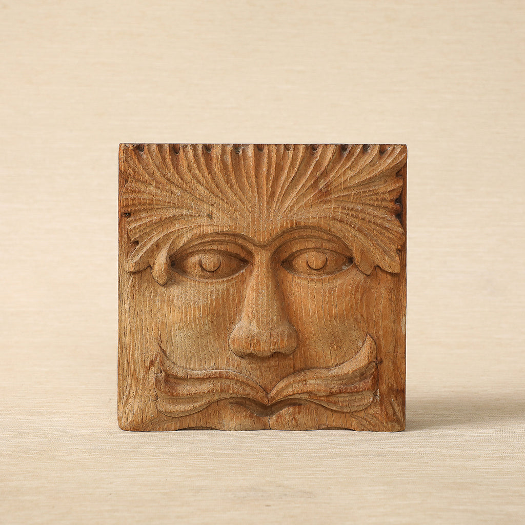 Hand carved wood block with face