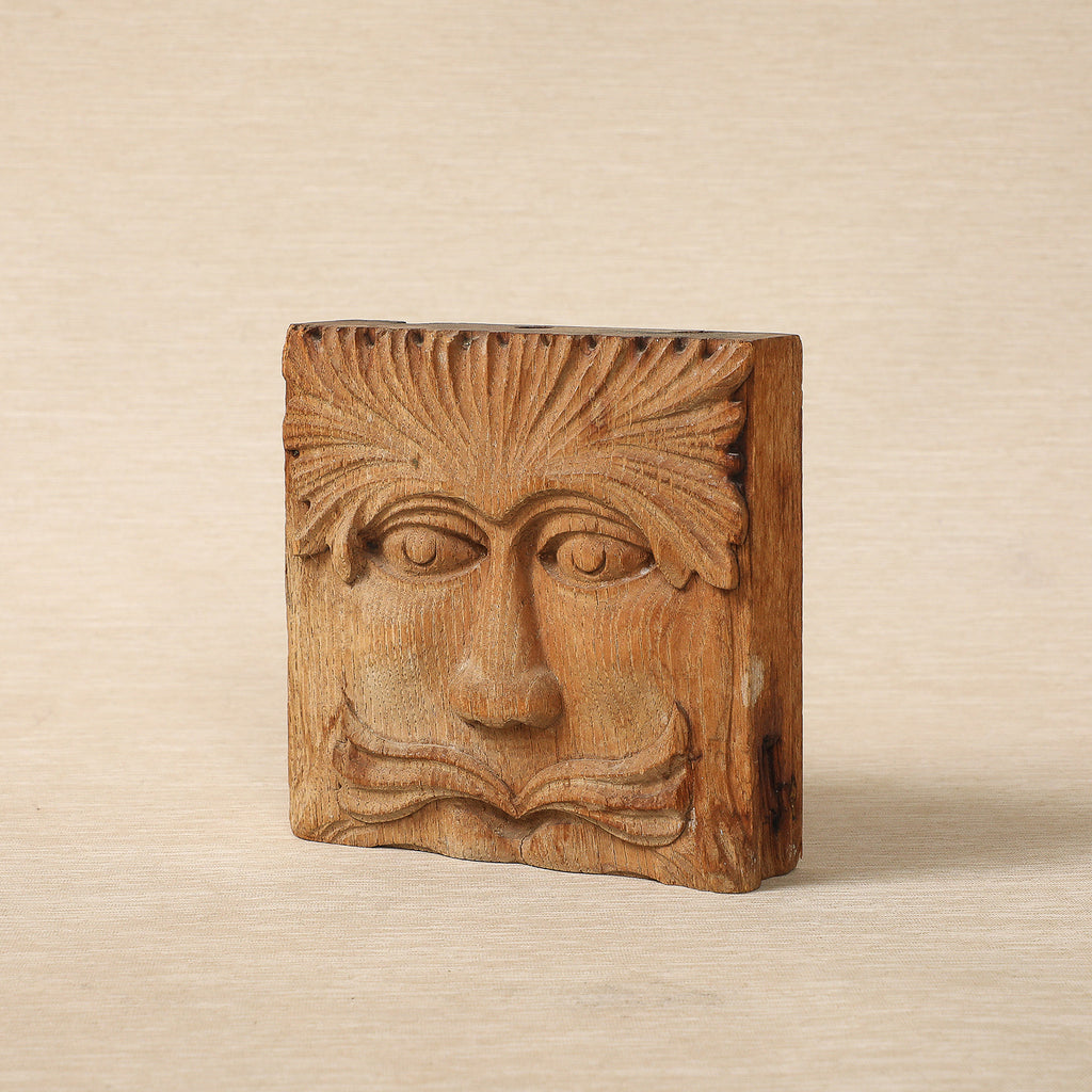 Hand carved wood block with face