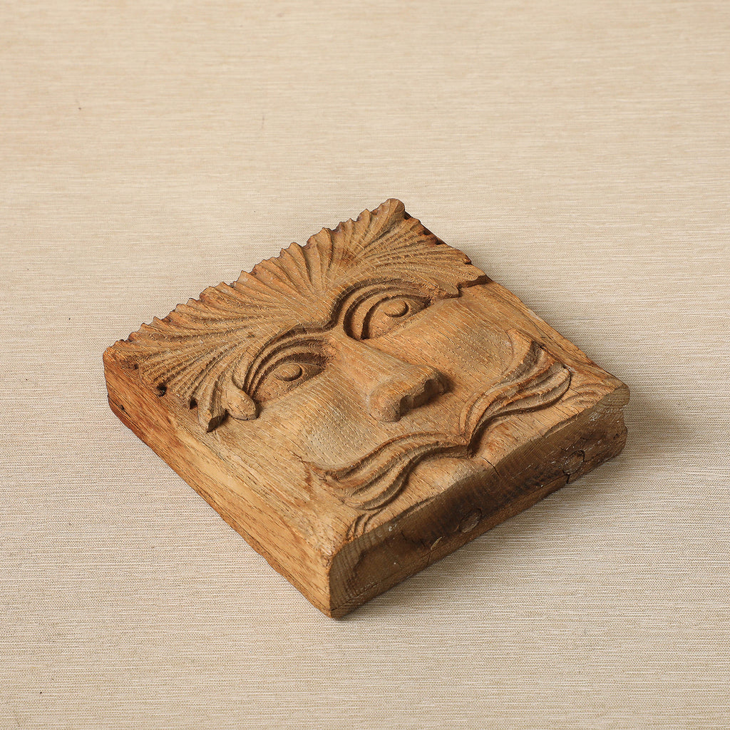Hand carved wood block with face