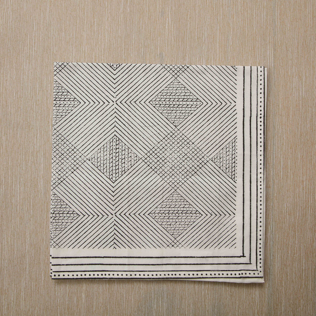 Block print cotton napkin in black and white grid pattern