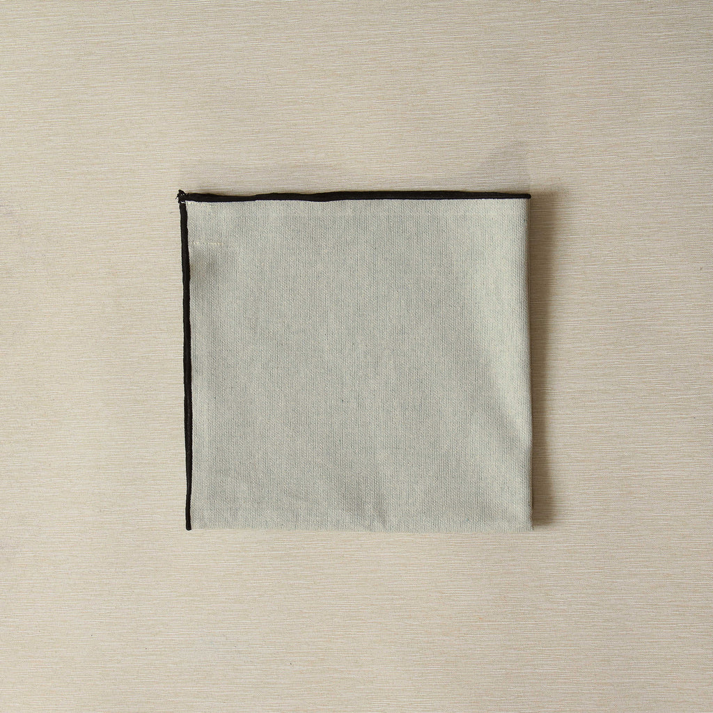 Mint napkin with black bourdon edge